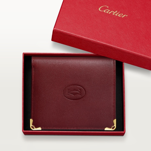 Must de Cartier vielseitige Brieftasche Bordeauxrotes Kalbsleder, Gold-Finish