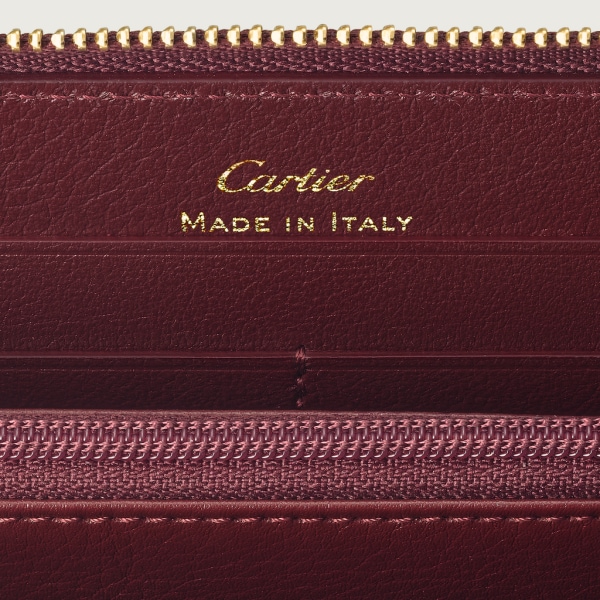 Must de Cartier Brieftasche mit Reißverschluss, internationales Format Bordeauxrotes Kalbsleder, Gold-Finish