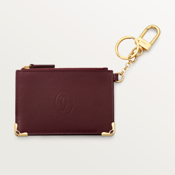 Porte-clés pochette Must de Cartier Cuir de veau bordeaux, finition dorée