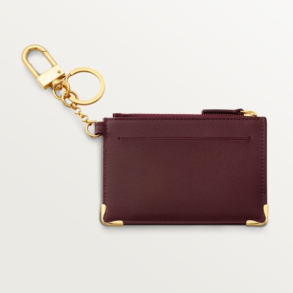 Porte-clés pochette Must de Cartier Cuir de veau bordeaux, finition dorée